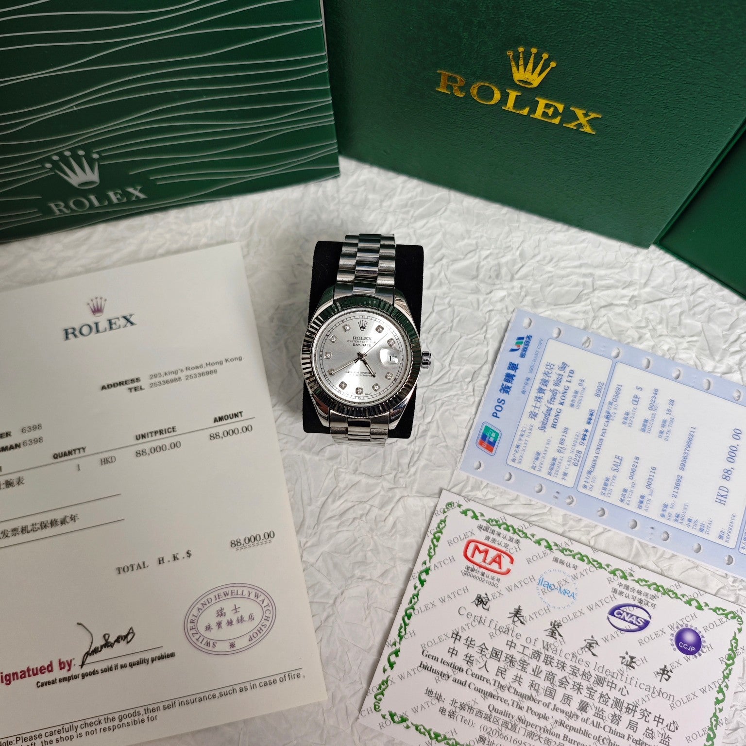Rolex wristwatch on paperwork with silver dial and steel bracelet, boxed set