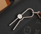 Louis Vuitton bag hardware: silver-tone key clasp on black leather trim