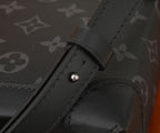 Louis Vuitton black strap tab close-up with round metal snap detail
