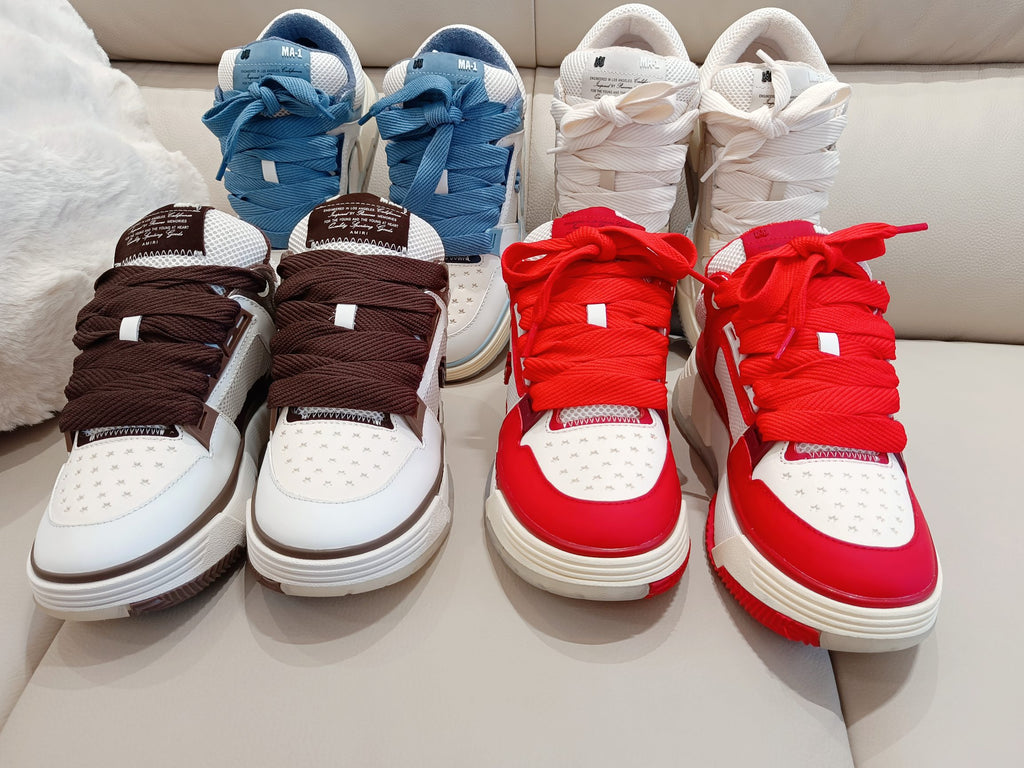 Four low-top sneakers in brown, blue, white, and red with lace-up fronts