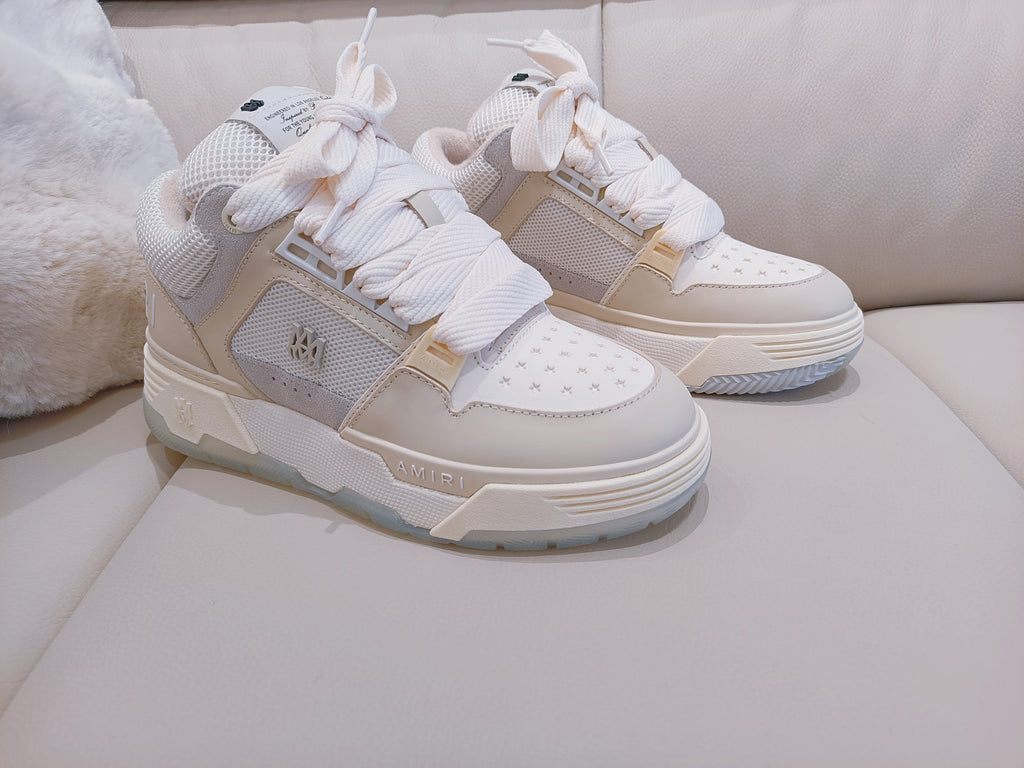 Pair of light beige and white high-top sneakers with lace-up front and padded collar