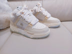 Pair of light beige and white high-top sneakers with lace-up front and padded collar