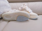 Sneakers showing white rubber outsole with blue-gray herringbone tread