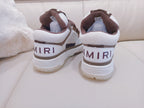 Brown and white low-top sneakers, back view with heel tabs