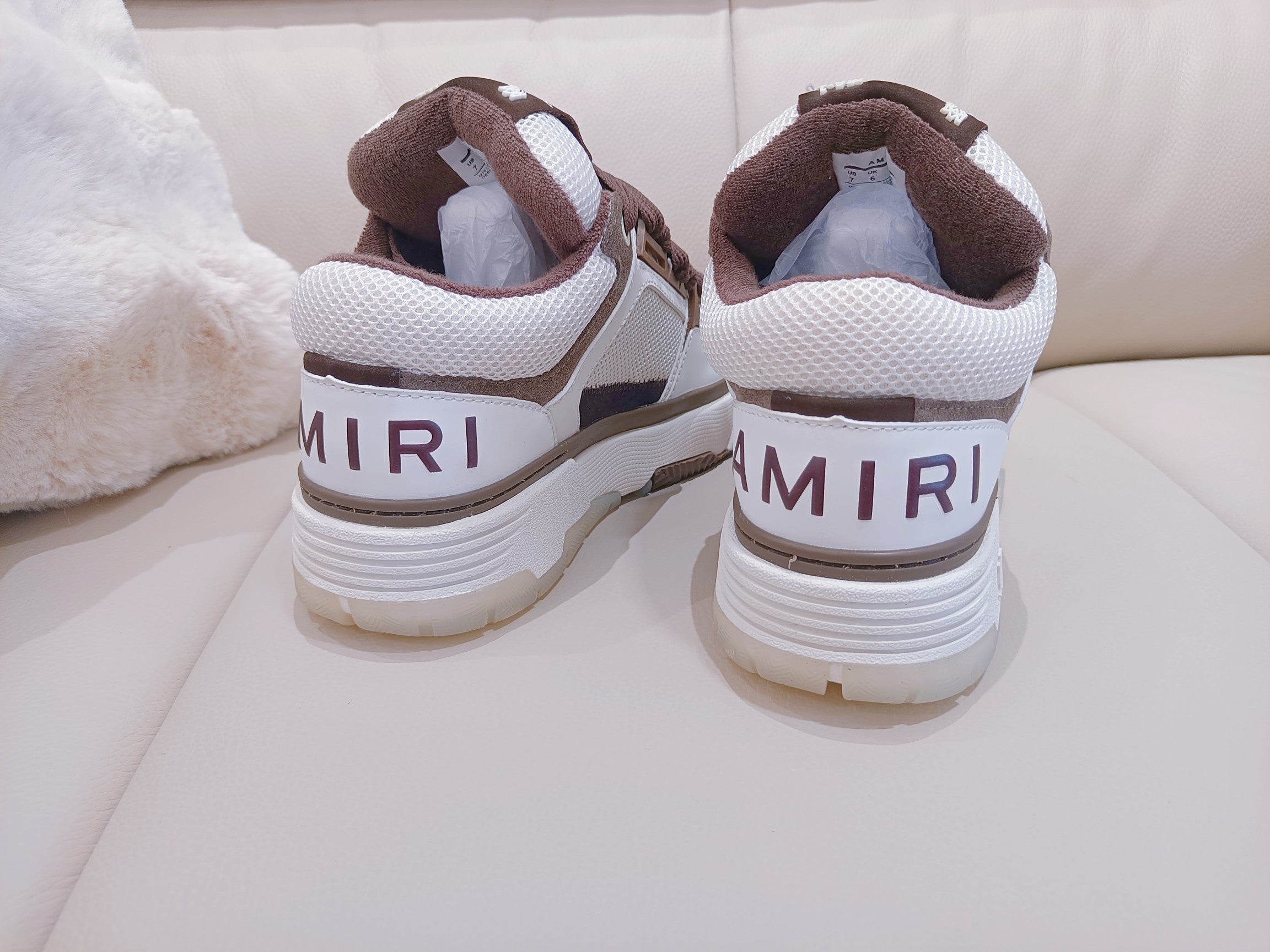 Brown and white low-top sneakers, back view with heel tabs