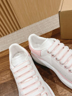 White sneakers with pink-striped laces and pink side accents, shown side-by-side