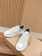 Alexander McQueen white sneakers with gray heel lining, lace-up design