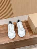 Alexander McQueen white low-top sneakers with gray heel and lace-up front