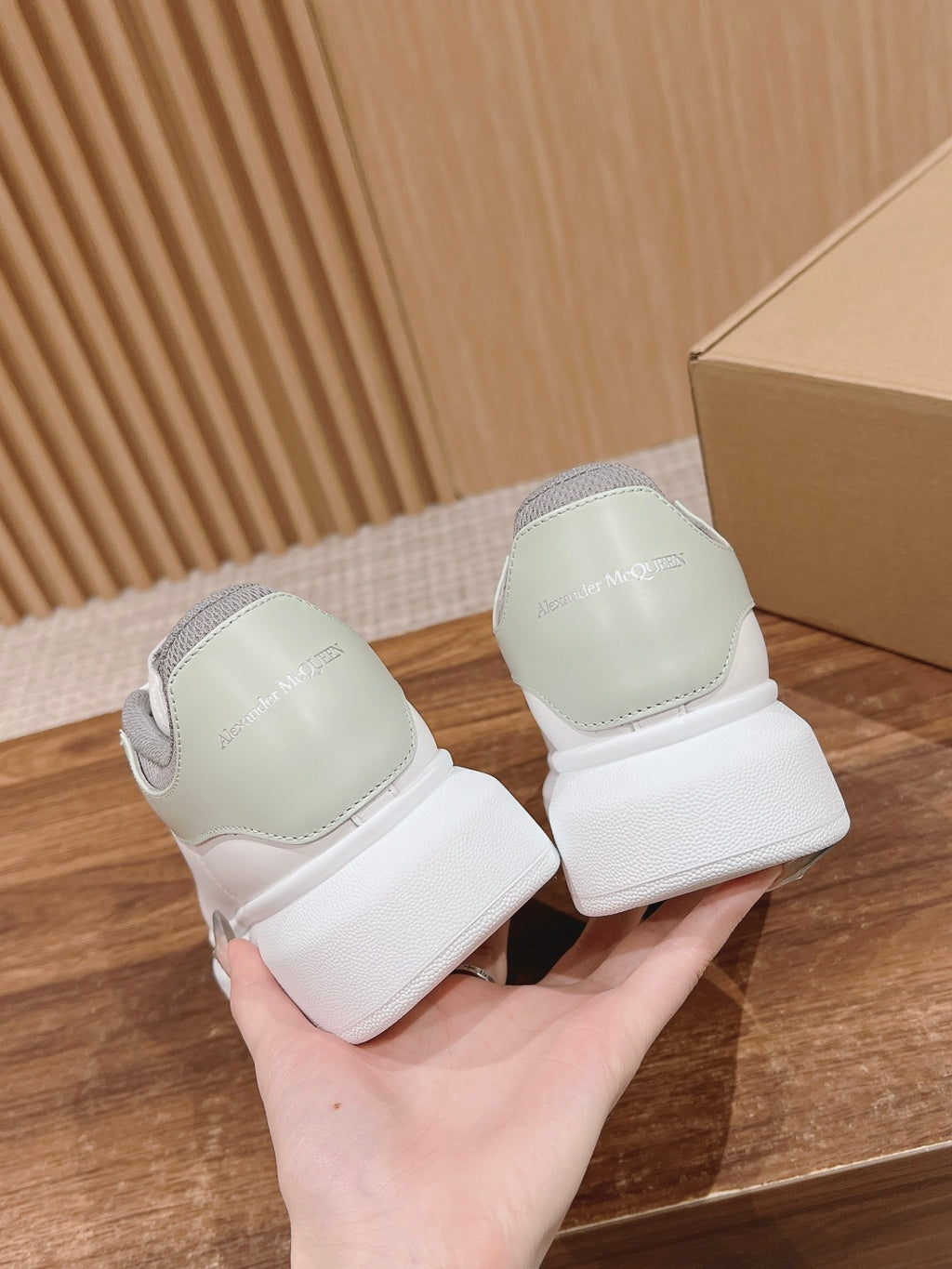 Alexander McQueen white sneakers with gray heel counters, rear view