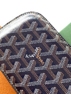 Small Goyard patterned pouch bag close-up with stitched edges and logo on the front