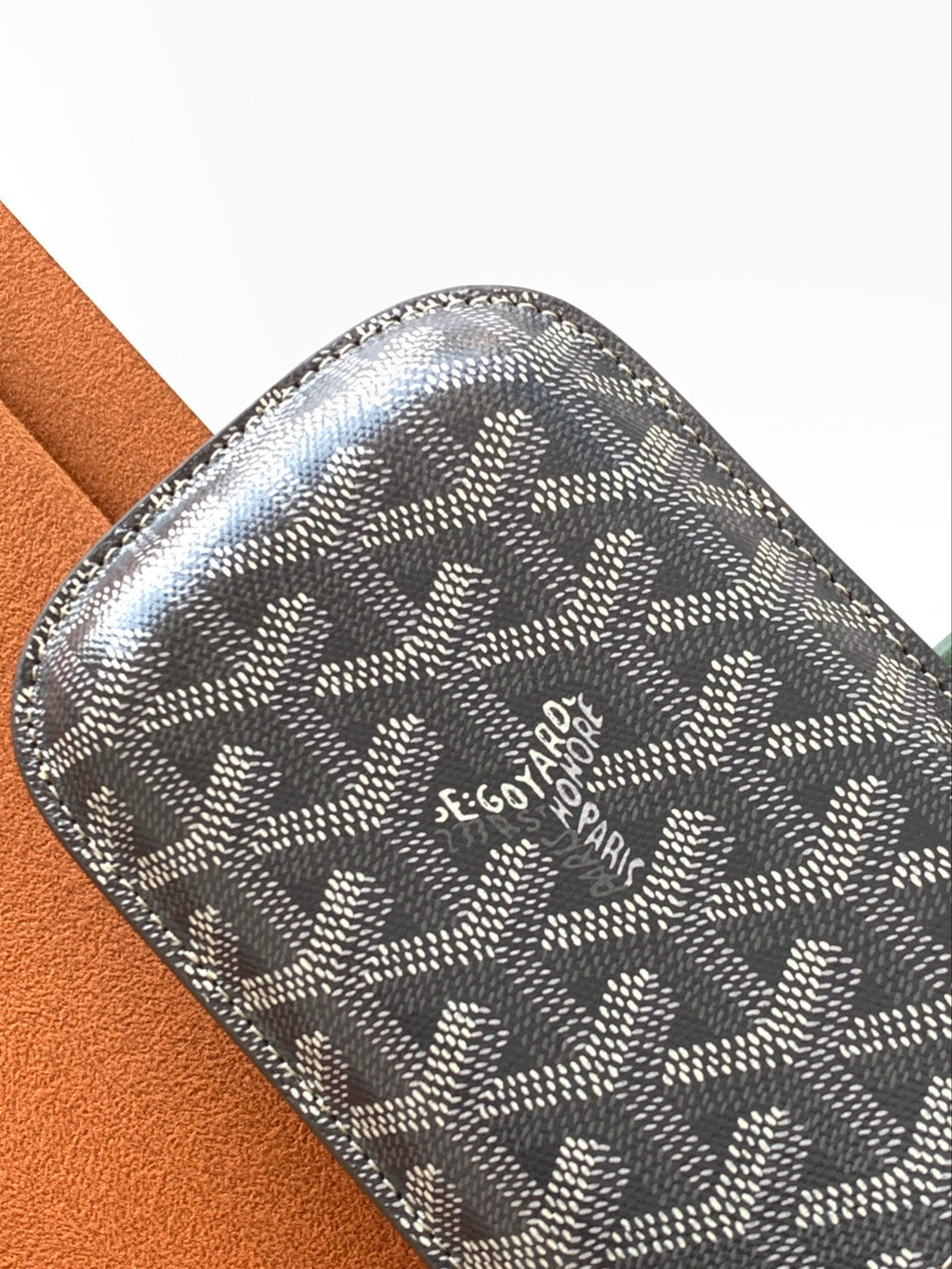 Goyard monogram mini pouch in gray with embossed logo at the center