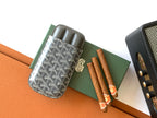 Goyard mini pouch with gray trim, holding two tubes, with gold emblem detail