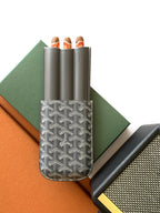 Goyard mini pouch with three tube slots and a gray patterned front panel
