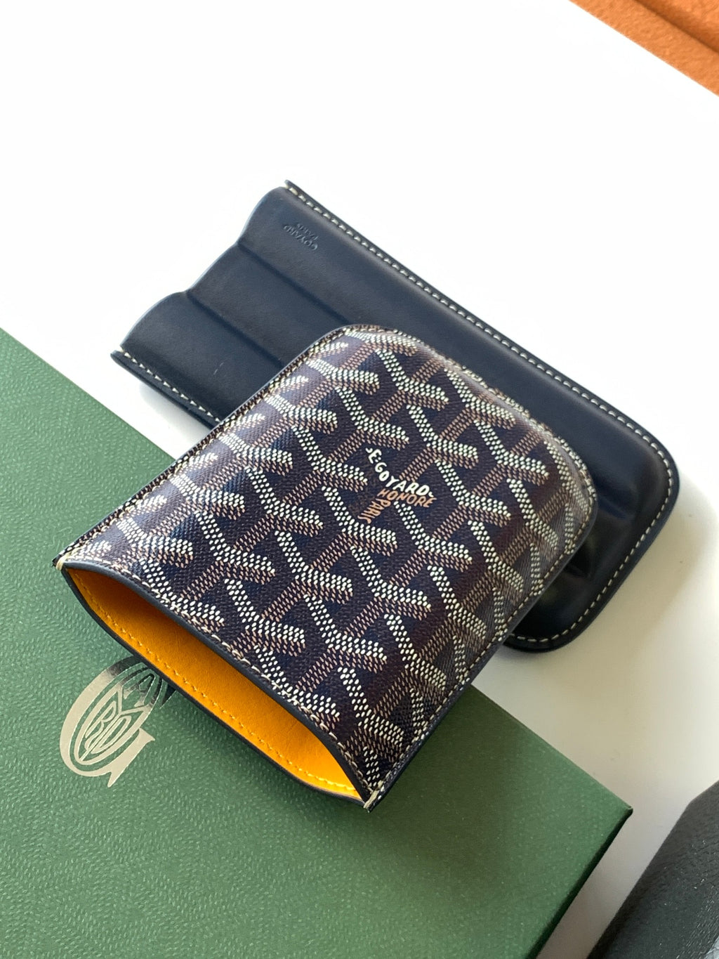 Small Goyard patterned pouch bag with navy leather trim and yellow interior lining