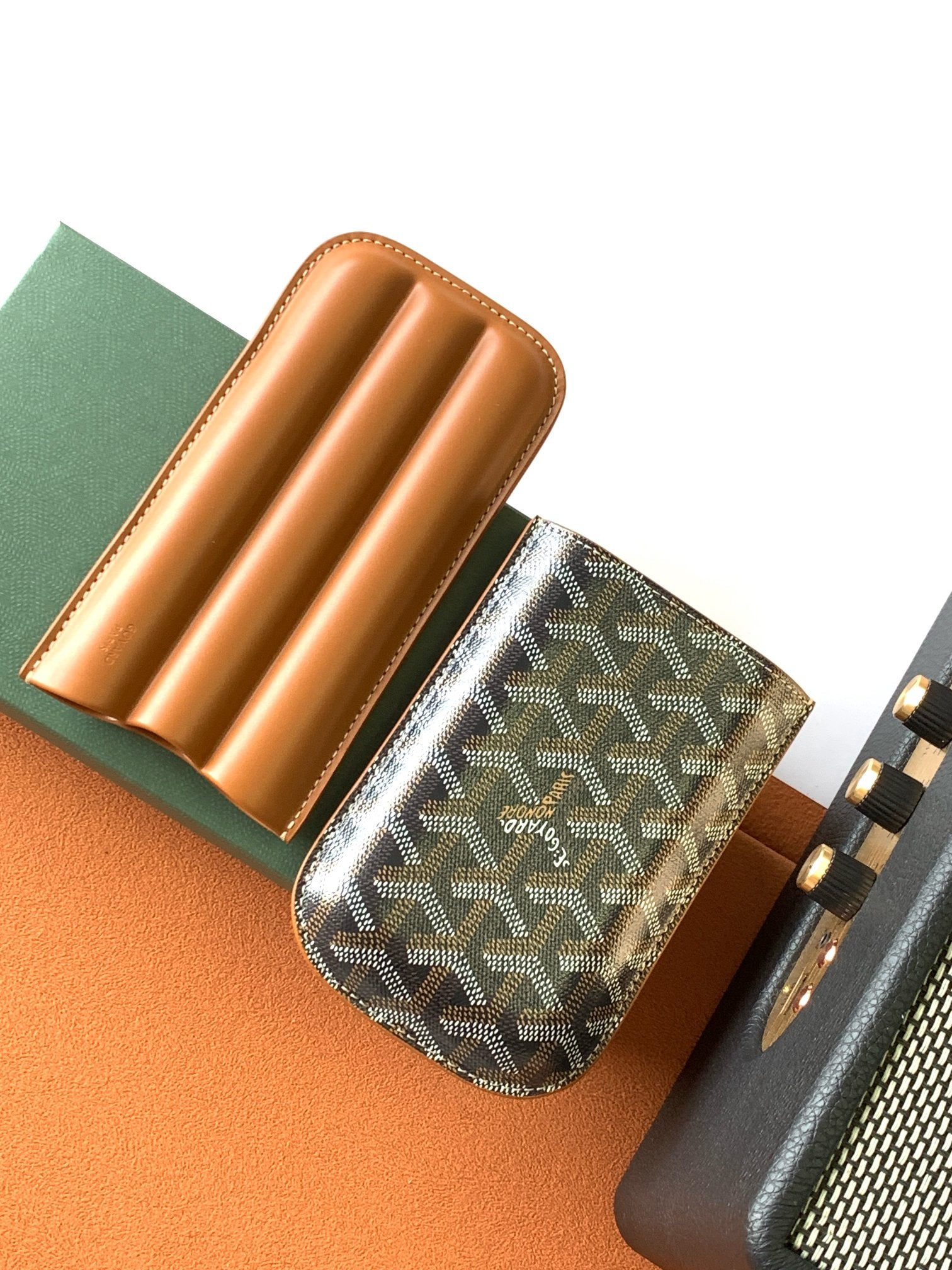 Goyard canvas bag with Goyardine pattern, tan leather organizer slots, dark side panel