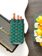 Goyard green patterned card holder standing upright with open slots