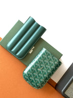 Goyard green patterned card holder open, showing multiple interior compartments