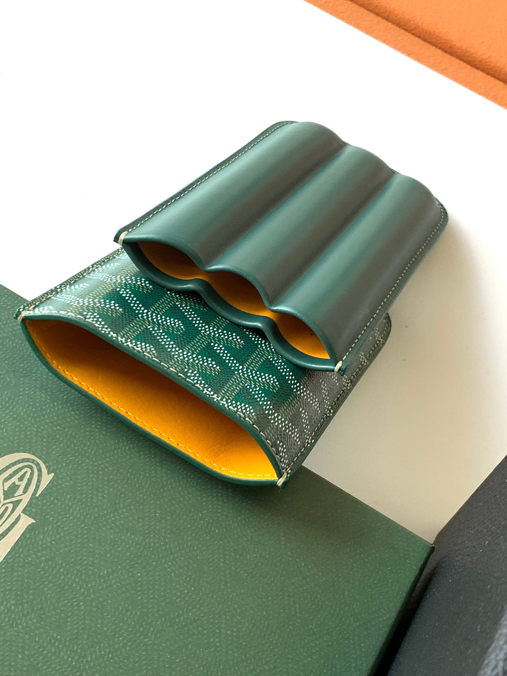 Goyard green leather card holder open with curved interior pockets