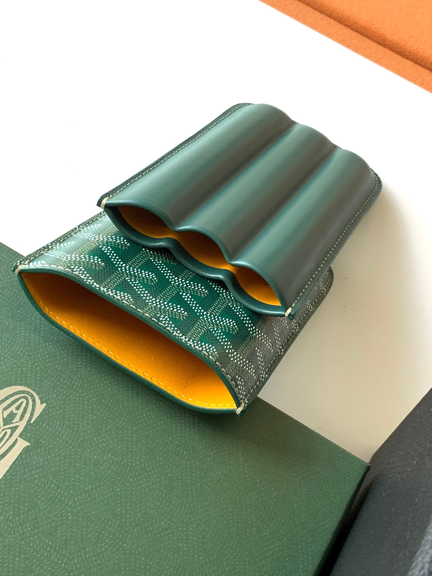 Goyard green leather card holder open with curved interior pockets