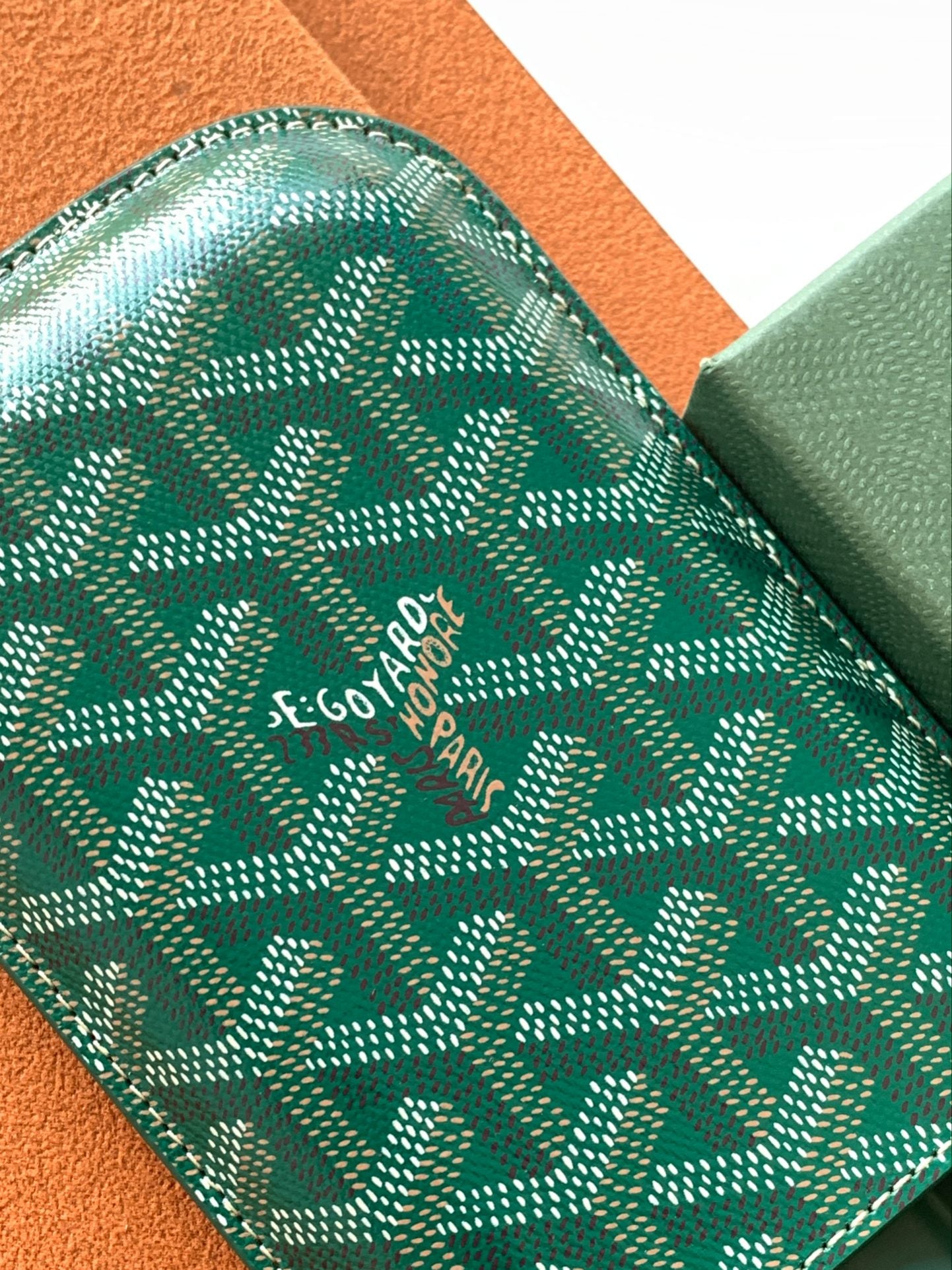 Goyard green patterned card holder with stitched edge and logo text