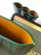Goyard green patterned card holder with orange-lined interior pockets