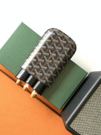 Goyard patterned bag with black leather trim and snap-style holder section
