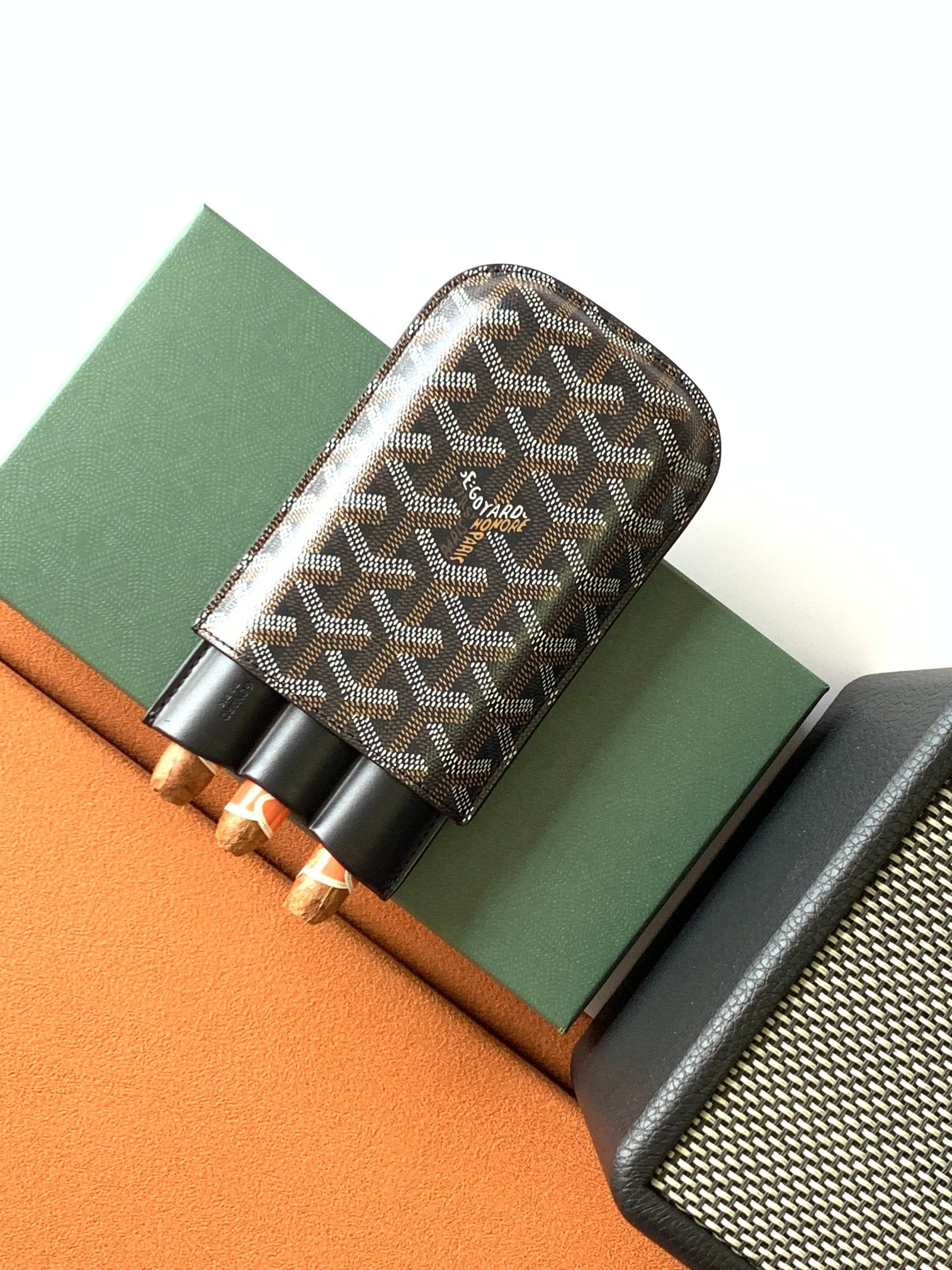 Goyard patterned bag with black leather trim and snap-style holder section