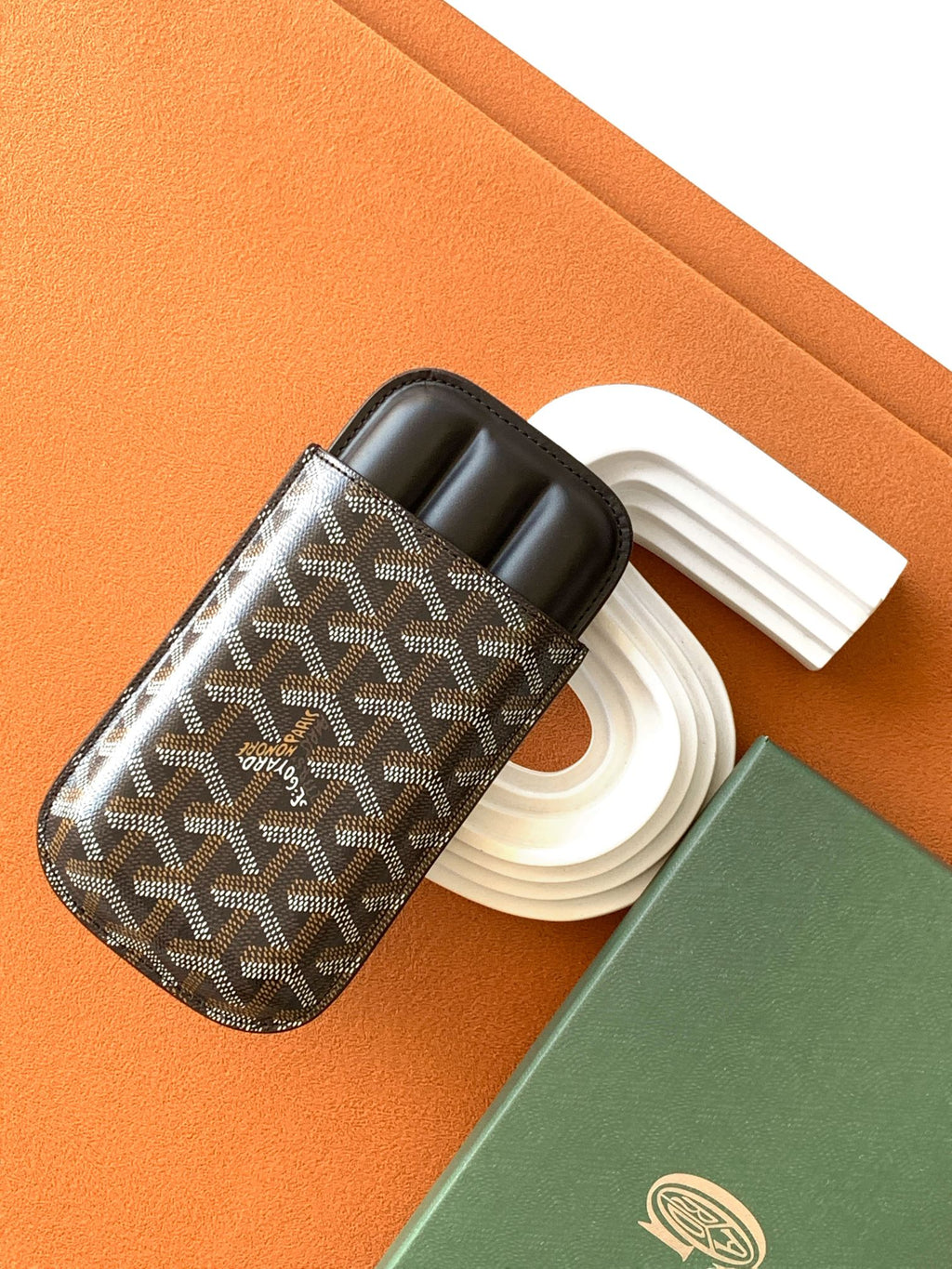 Goyard patterned bag with black leather trim, open top, and holder slot details