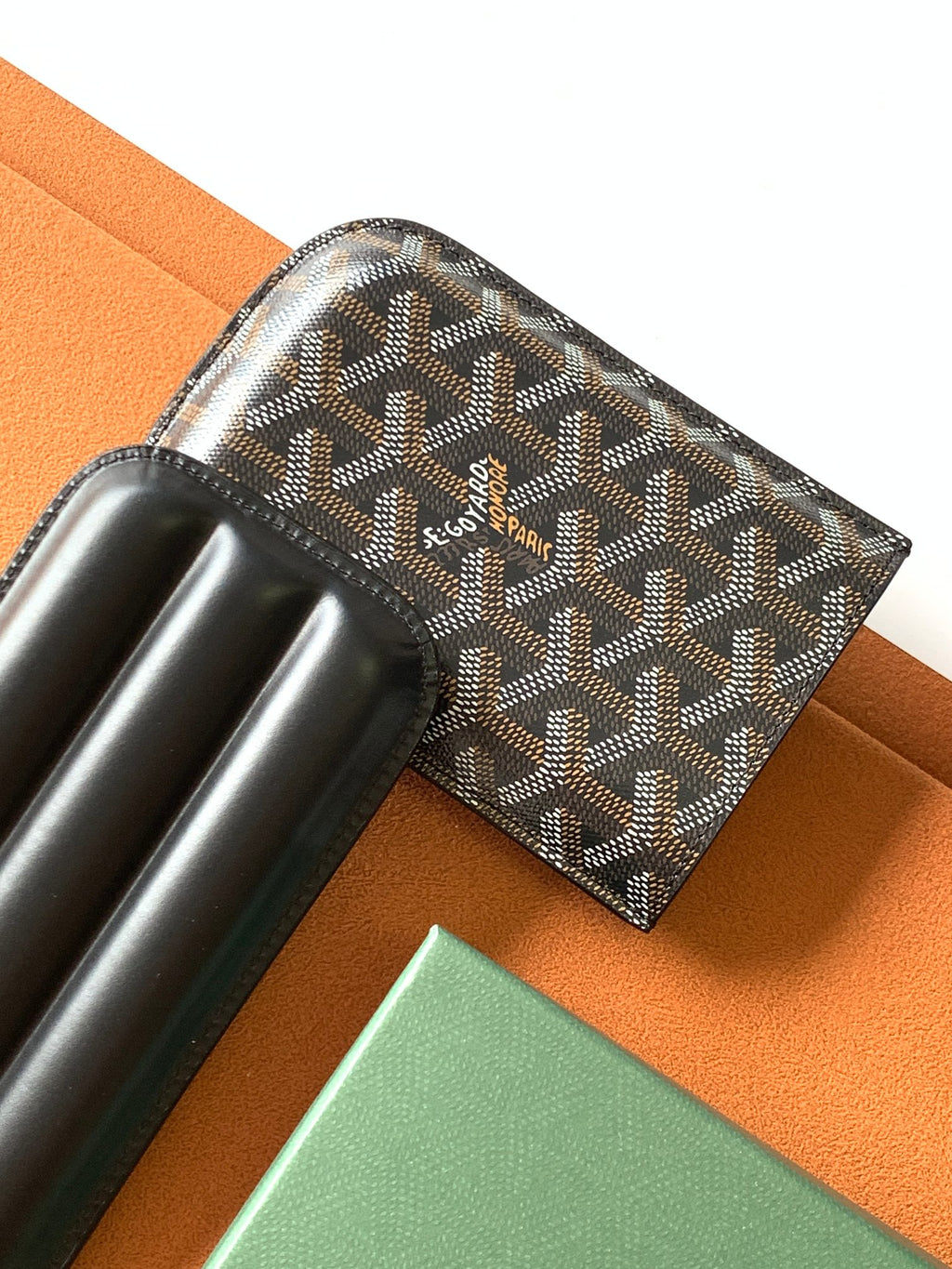 Goyard patterned bag with black leather base and horizontal holder opening