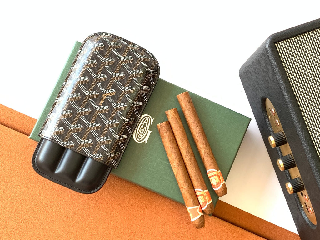 Goyard patterned bag with black leather base and visible accessory holder slots