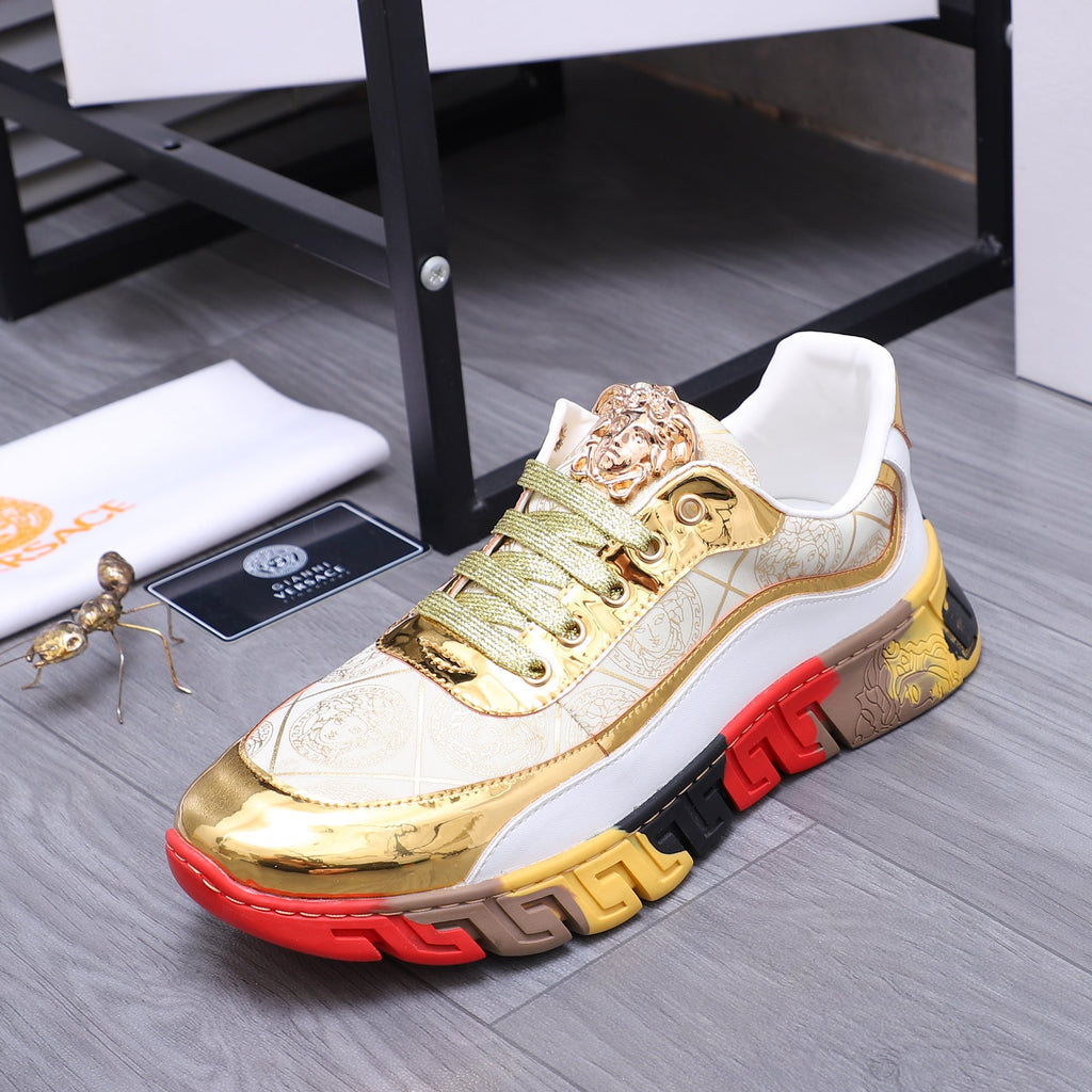 Luxury sneakers close side view with gold leather-look toe, green laces, and chunky red/black sole