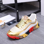 Luxury sneakers close side view with gold leather-look toe, green laces, and chunky red/black sole