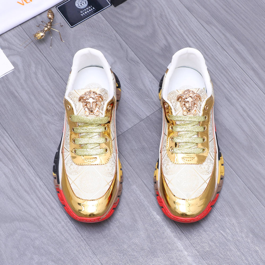 Luxury sneakers front view: white uppers with gold toe caps and panels, green lace-up, red sole
