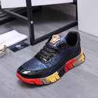 Low-top athletic sneakers, black and blue upper with gold lion crest and chunky sole