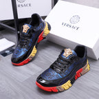 Low-top athletic sneakers, black with blue patterned trim and gold lion crest