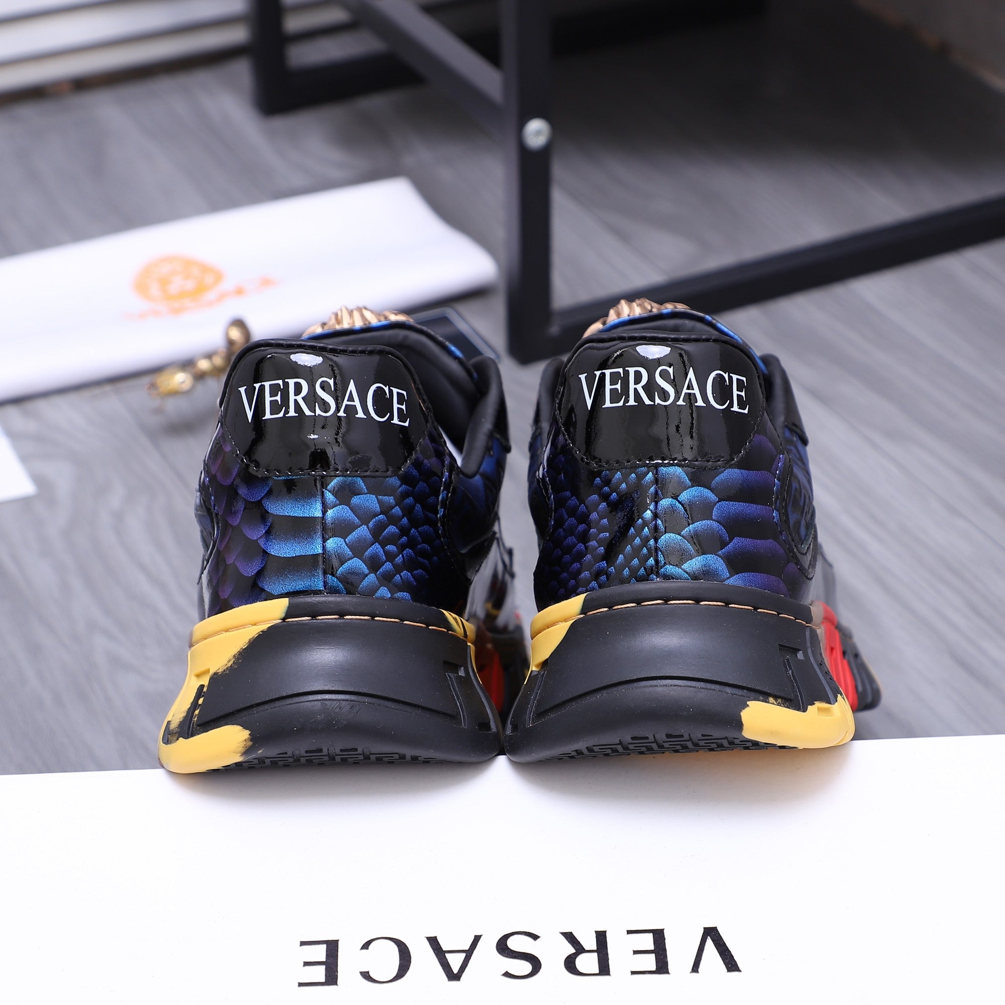 Low-top athletic sneakers, black and blue with rear logo print and chunky sole