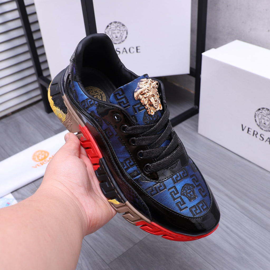 Low-top athletic sneakers, black and blue with gold lion logo and red sole detail