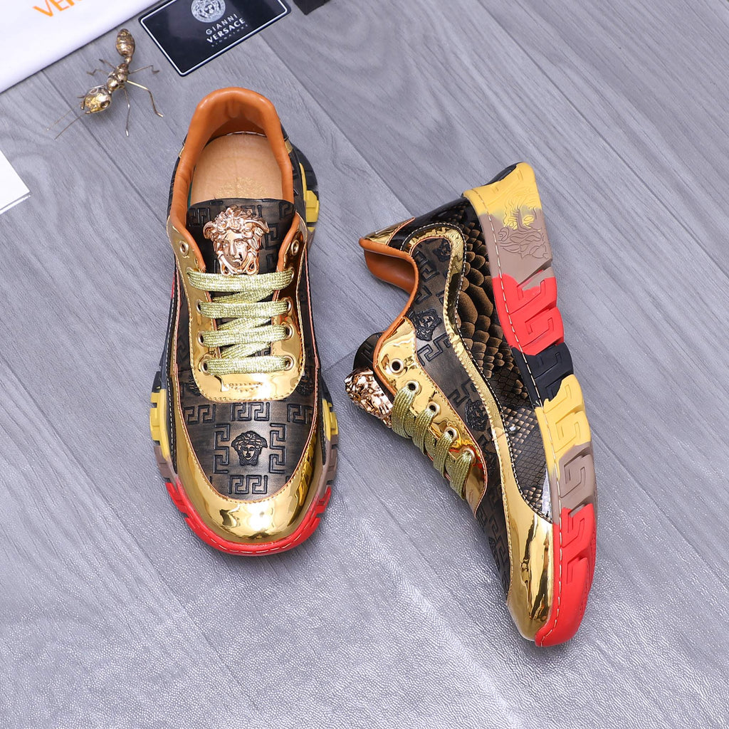 Luxury sneakers, gold toe with Medusa emblem, navy upper with Greek key style, red sole