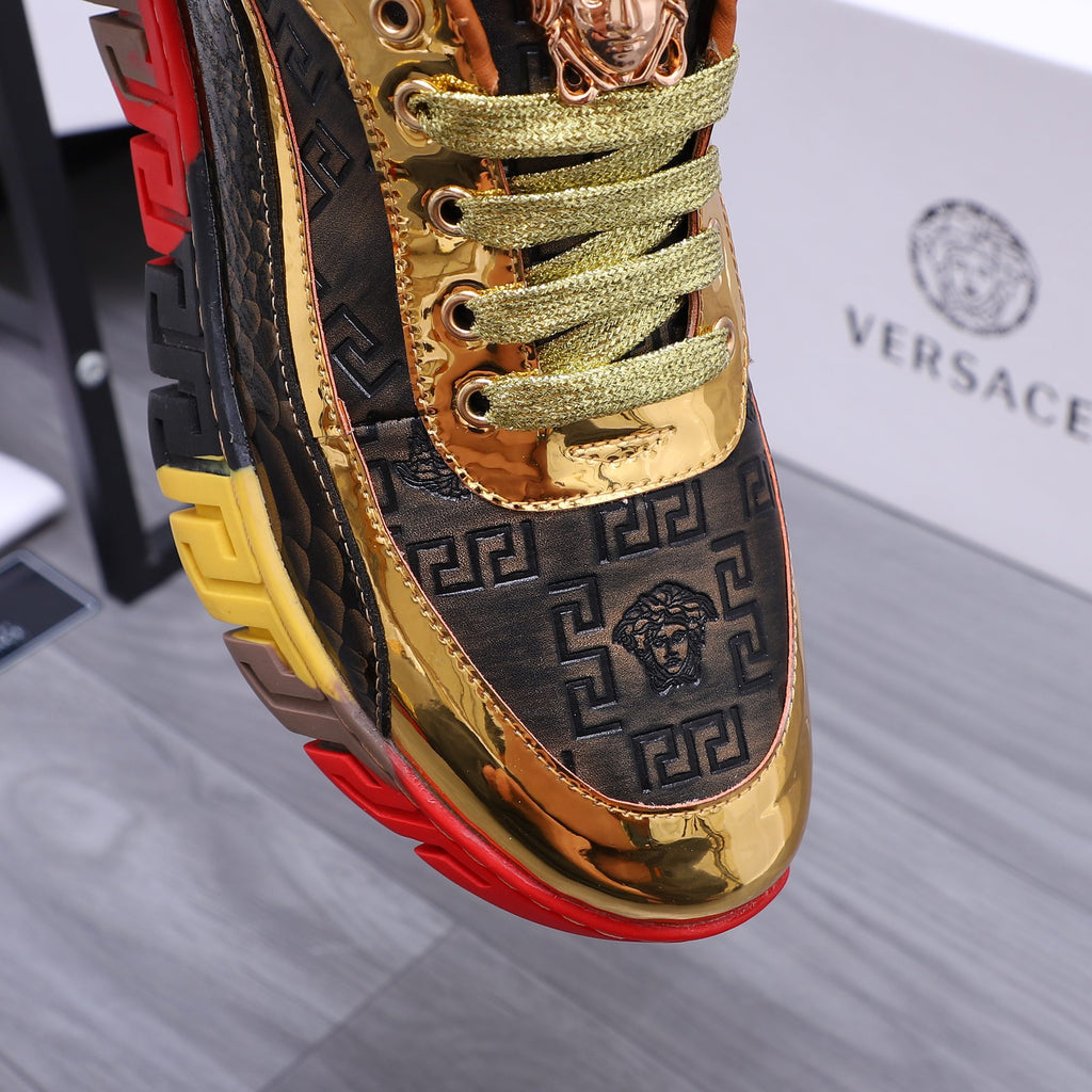 Luxury sneakers close-up of gold tongue and navy logo side panel, green laces, red sole edge
