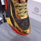 Luxury sneakers close-up of gold tongue and navy logo side panel, green laces, red sole edge