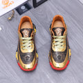 Luxury sneakers, gold toe, navy monogram panels, green laces, red/yellow chunky sole