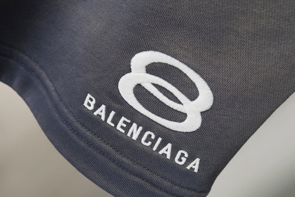 Balenciaga patch logo on dark gray shorts leg