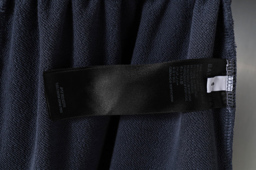 Balenciaga interior care label strip on dark gray shorts