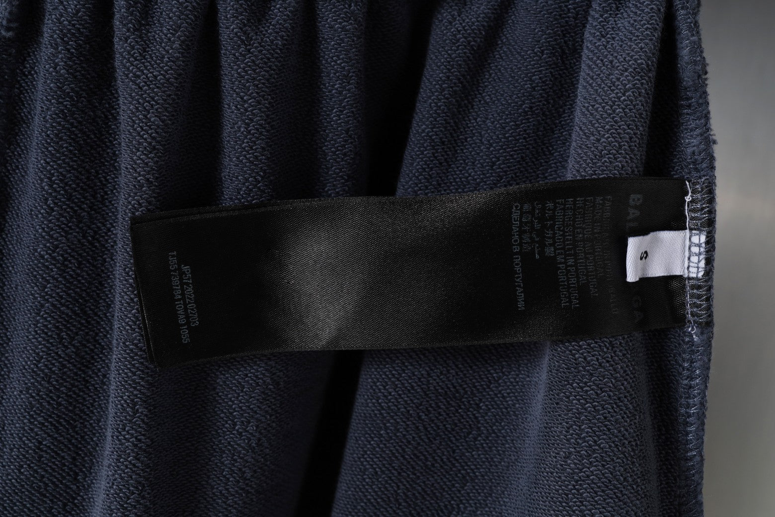 Balenciaga interior care label strip on dark gray shorts