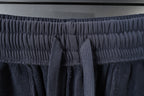 Balenciaga drawstring knot at elastic waistband, dark gray shorts