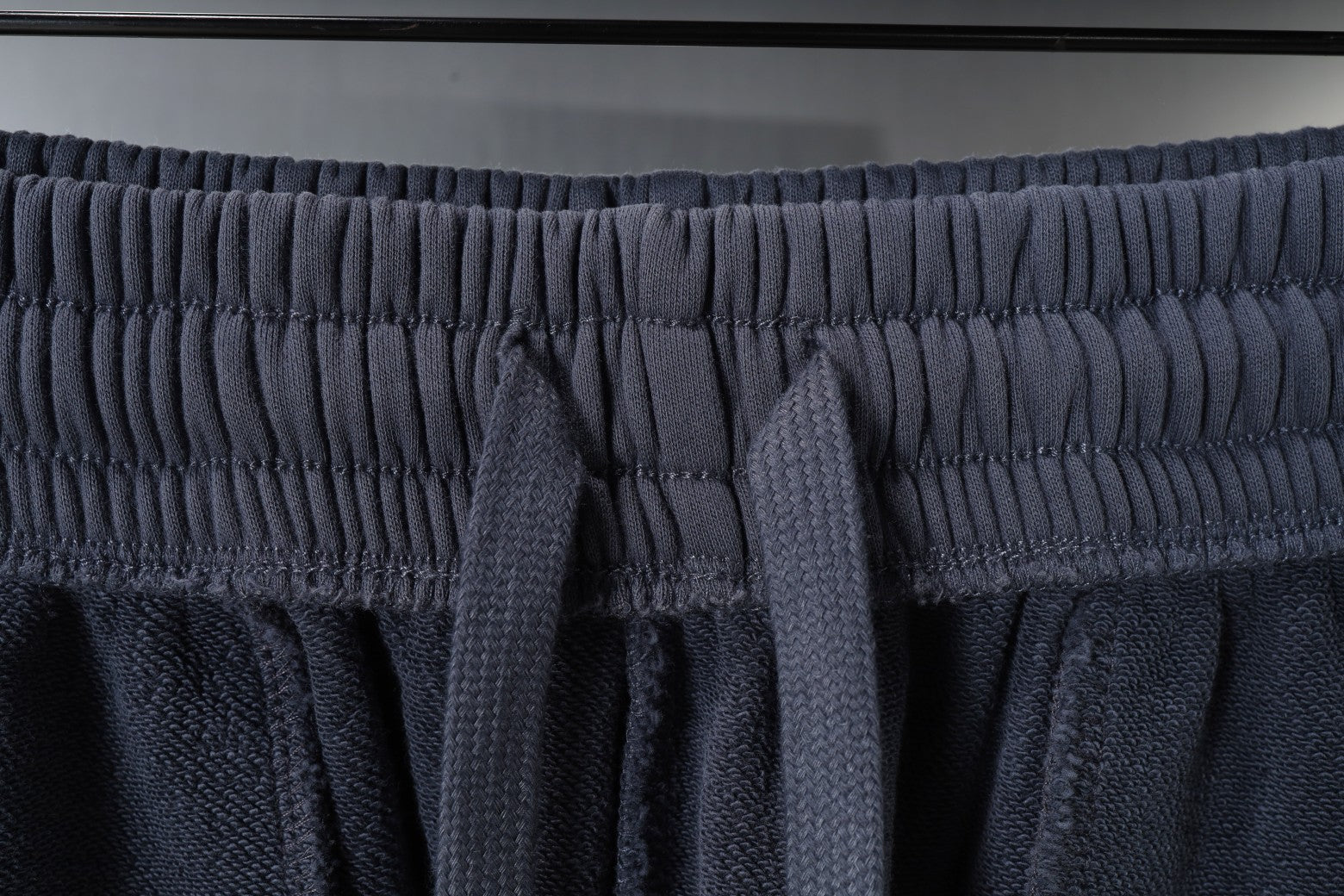 Balenciaga drawstring knot at elastic waistband, dark gray shorts