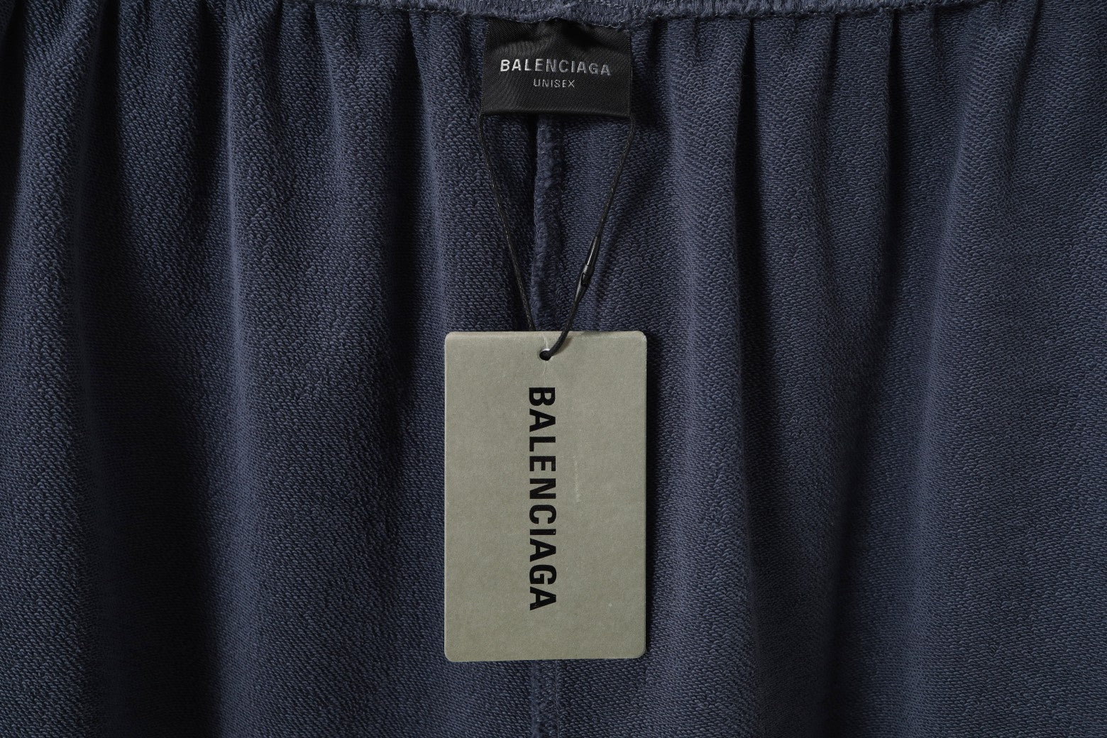 Balenciaga inner waistband label on dark gray shorts