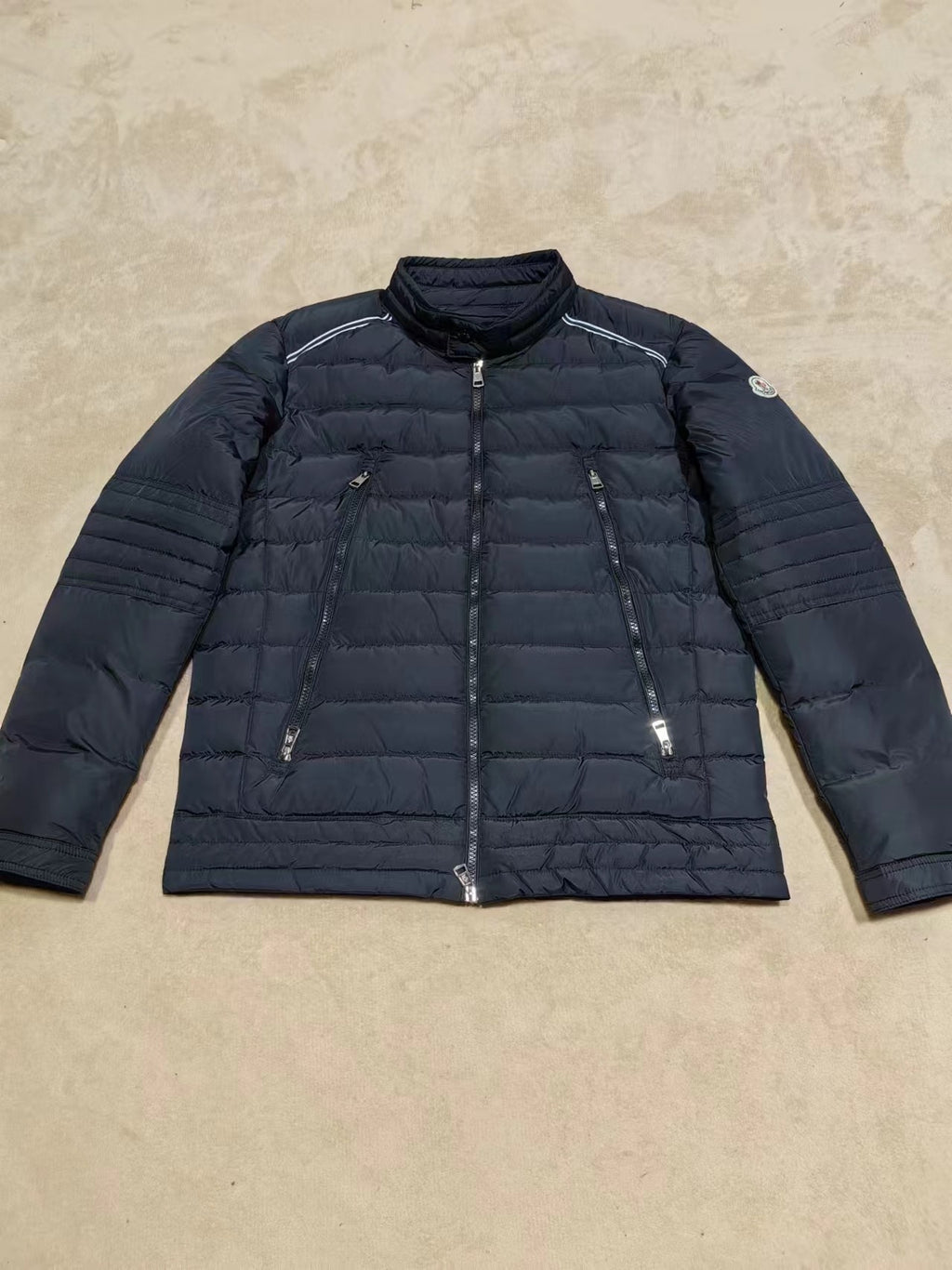 Moncler long dark puffer jacket with zip front and quilted sleeves