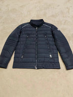Moncler long dark puffer jacket with zip front and quilted sleeves