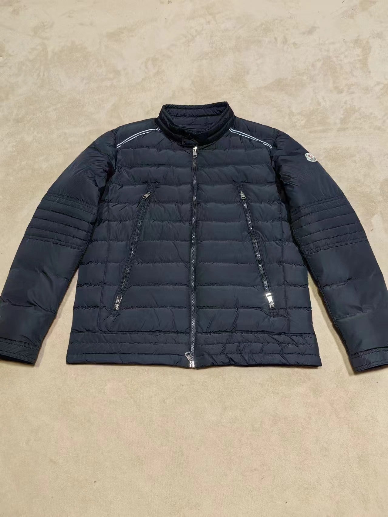 Moncler long dark puffer jacket with zip front and quilted sleeves
